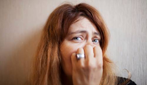 woman with her hand over her face