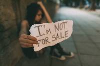 person holding a sign that says I'm not for sale